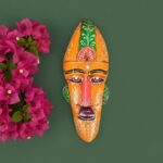 Furnshine -  Handcrafted Orange Wooden Tribal Wall Mask with Green Accents – Nazar Battu for Home Entrance, Living Room & Balcony Decor – 12 Inch Ethnic Hanging Art
